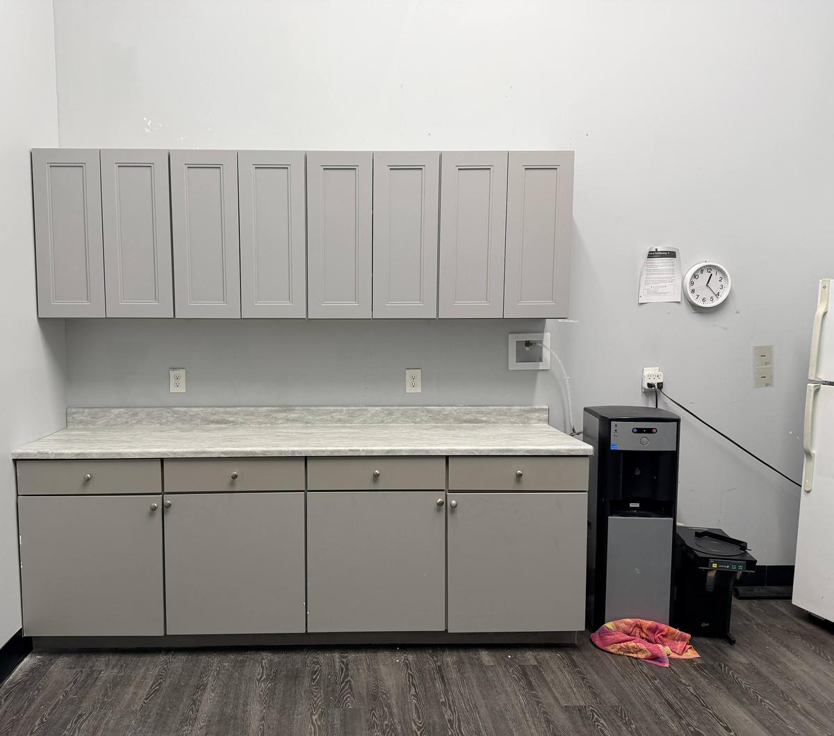 Completed break room wall cabinets installed above the countertop