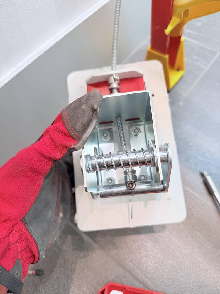 Electrical box being installed into a drywall partition in a commercial building
