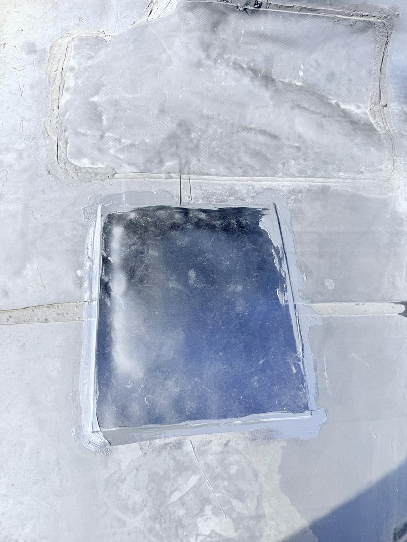EPDM patch installed on a commercial flat roof to stop a leak