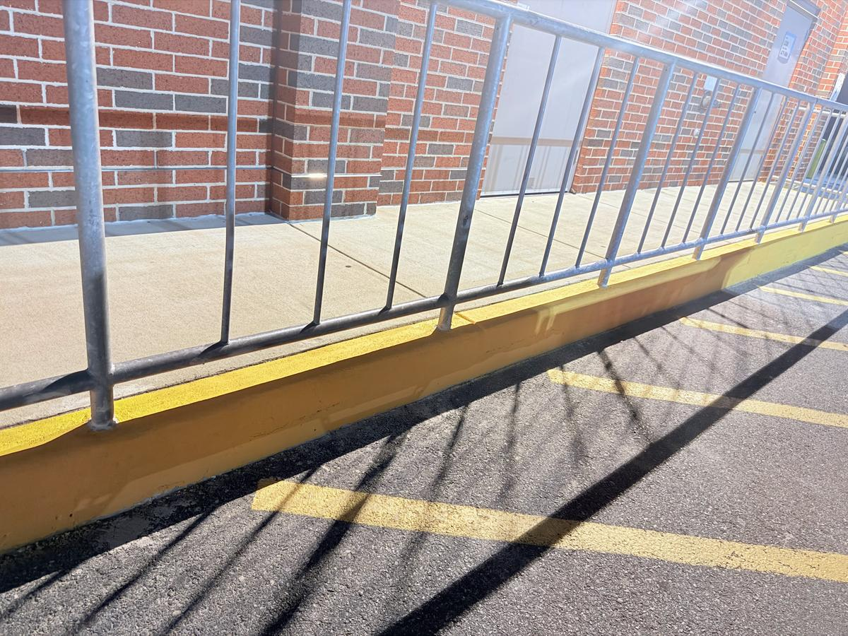 Completed concrete repair along a commercial walkway
