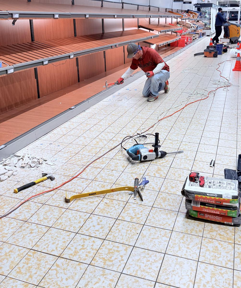 Damaged floor tile removed and replaced in an operating commercial store