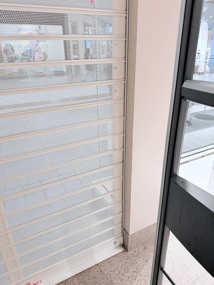 Storefront security grille serviced and repaired