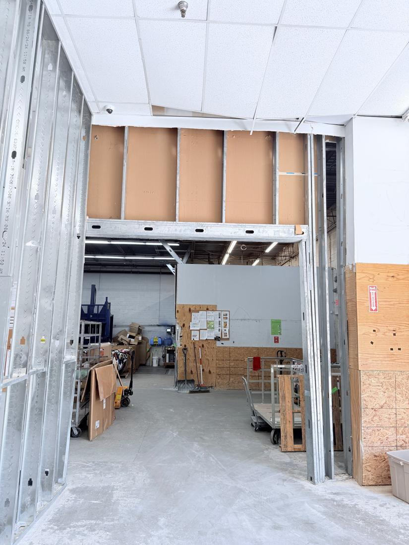 Rebuilt commercial wall in metal stud framing with a new framed opening